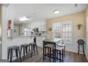 Eat-in kitchen with granite counters, a breakfast bar, white cabinets, and stainless steel appliances at 1421 Saint Charles Ct, Conyers, GA 30094