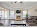 Elegant living room with fireplace, hardwood floors, trey ceiling, and ample natural light at 1421 Saint Charles Ct, Conyers, GA 30094