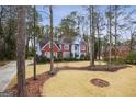 Beautiful front yard featuring a well-manicured lawn and trees surrounding an elegant home at 9163 Retreat Pass, Jonesboro, GA 30236