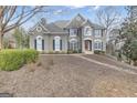 Traditional two-story home with landscaped front yard, neutral stucco, and dark shutters on bright windows at 804 Carnellian Ln, Peachtree City, GA 30269