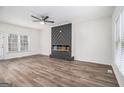 Open living area with modern fireplace, neutral walls, ceiling fan, and luxury vinyl plank flooring at 1320 Kay Se Ter, Conyers, GA 30013