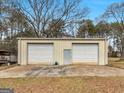 A spacious barn offers ample storage with its double garage doors and a convenient side entrance at 6393 Walker Rd, Riverdale, GA 30296