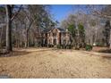 Charming two-story brick home featuring a classic design with well-maintained landscaping and mature trees surrounding the property at 302 Cumberland Ct, Peachtree City, GA 30269