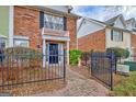 Charming brick townhome featuring a manicured front yard and walkway, inviting curb appeal at 498 N Jeff Davis Dr, Fayetteville, GA 30214