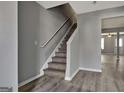 Gray staircase complemented by modern gray walls, leading to the upper level of the home at 1915 Grove Way, Hampton, GA 30228