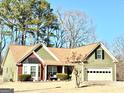 Inviting one-story home with an attached two-car garage, trimmed bushes and well-kept lawn at 222 Sandstone Dr, Hampton, GA 30228