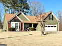 Delightful one-story home featuring an attached two-car garage, established landscaping, and manicured lawn at 222 Sandstone Dr, Hampton, GA 30228