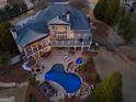 Expansive aerial view of the property showcasing the pool, patio, lush landscaping, and well-maintained grounds at 300 Annelise Park Dr, Fayetteville, GA 30214