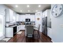 Bright kitchen featuring white cabinetry, stainless steel appliances, and a cozy dining nook at 70 High Point Way, Hiram, GA 30141