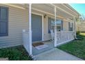 Welcoming front porch with seating area, perfect for enjoying quiet mornings at 33 Chelsea Ln, Grantville, GA 30220