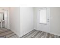 Bright entryway features stylish gray flooring and a view into the adjacent bathroom at 293 Limestone Circle, Conyers, GA 30013