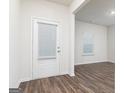 Bright entryway featuring neutral walls, wood-look floors, and a door with a built-in window at 1041 Claas Way, Locust Grove, GA 30248