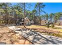 Beautiful traditional home situated on a sprawling lot surrounded by a lush, mature forest and private drive at 135 Weeping Willow Way, Tyrone, GA 30290