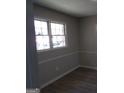 Picture of a room with laminate flooring, grey walls, and a window letting in natural light at 2401 Northlake Ct, Atlanta, GA 30345