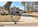 Inviting two-story home with a well-maintained lawn and a long driveway leading to an attached two-car garage at 2561 Rainover Ct, Decatur, GA 30034