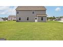 Spacious backyard featuring a lush green lawn perfect for outdoor activities and relaxation at 275 Oliver Dr, Locust Grove, GA 30248