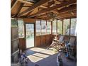 A screened porch featuring rocking chairs and a wood ceiling at 4748 Ash St, Doraville, GA 30340