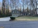 Charming two-story home with a two-car garage, complemented by dark shutters and manicured lawn at 3370 Creek Hollow Dr, Marietta, GA 30062