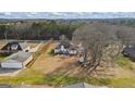 Wide aerial shot showcases the home's generous lot, mature trees, and inviting outdoor space at 3403 Bill Gardner Pkwy, Locust Grove, GA 30248