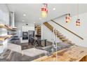 An open kitchen with a custom island, stainless appliances, unique floating staircase, and modern finishes at 560 John Wesley Dobbs Ne Ave, Atlanta, GA 30312