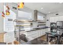A contemporary kitchen with white cabinets, modern appliances, and a stylish island with seating at 560 John Wesley Dobbs Ne Ave, Atlanta, GA 30312