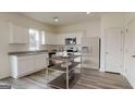 Modern kitchen featuring white cabinets, granite countertops, and stainless steel appliances at 7728 Sudbury Cir, Covington, GA 30014