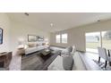 Bright living room with large windows, comfortable seating, and neutral decor at 7728 Sudbury Cir, Covington, GA 30014