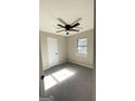 Neutral bedroom with new carpet, a window, and a modern ceiling fan at 95 Grove Creek Dr, Locust Grove, GA 30248