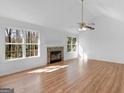 Spacious living room with a fireplace and large windows offering natural light at 150 Grove Creek Dr, Locust Grove, GA 30248