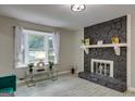 Bright living room with stone fireplace, large window, and modern decor at 317 Lucan Way, Riverdale, GA 30274
