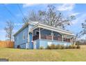 Charming blue home featuring a metal roof and an inviting front porch at 1616 Park Ne St, Conyers, GA 30012