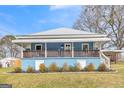 Charming blue home featuring a metal roof and an inviting front porch at 1616 Park Ne St, Conyers, GA 30012