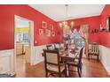 Dining room with wainscoting, decorative lighting, and an exquisite dining table set at 3867 Summer Kitchen Way, Lilburn, GA 30047