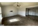 Bright living room featuring a vaulted ceiling and a ceiling fan at 133 Dove Lndg, Social Circle, GA 30025