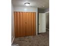 View of empty bedroom with carpet, bi-fold closet, ceiling light, and open door at 186 Governors Dr, Forest Park, GA 30297