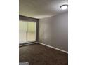 View of empty bedroom with carpet, gray walls, ceiling light, and window with blinds at 186 Governors Dr, Forest Park, GA 30297