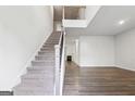 Bright open-concept living area boasts hardwood floors, a fireplace, and a staircase leading to the second floor at 604 Clark Lake Estates Dr, Grayson, GA 30017
