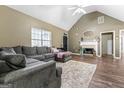 Inviting living room with high ceilings, a cozy fireplace, and stylish flooring perfect for relaxing and entertaining at 1012 Matthews Way, Mcdonough, GA 30252