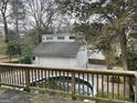 Backyard featuring an above ground pool, a deck with wood railings, and a detached garage at 1867 Dresden Dr, Atlanta, GA 30319