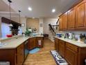 Spacious kitchen with wooden cabinets, stainless appliances, and hardwood flooring at 306 Oakwind Way, Canton, GA 30114
