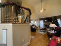 Open living room with hardwood floors, cathedral ceilings, and a cozy stone fireplace at 306 Oakwind Way, Canton, GA 30114