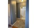 Bathroom with carpeted hallway and a view of the white bathtub and shower through the doorway at 8537 Spivey Village Trl, Jonesboro, GA 30236