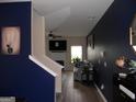 View from stairs into the living room featuring a fireplace and hardwood flooring at 620 Calvo Run, Mcdonough, GA 30253