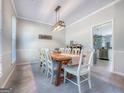 Well-lit dining room with a rustic wooden table and seating for eight, perfect for gatherings at 407 Holly Grove Church Rd, Peachtree City, GA 30269