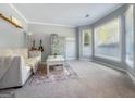 Cozy living room with neutral walls, bright windows, a comfortable couch, and stylish decor at 407 Holly Grove Church Rd, Peachtree City, GA 30269