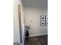 Hallway decor featuring framed prints and a decorative plant in a black pot on a stool at 11569 Kimberly Way # 26, Hampton, GA 30228