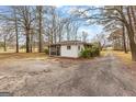 Detached garage with gravel driveway and screened in porch at 1115 Highway 54 East, Fayetteville, GA 30214