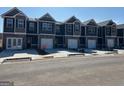 New community of townhomes featuring garage parking, craftsman style architecture, and well-manicured landscaping at 111 Meadowview Dr # 21, Temple, GA 30179