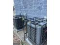 Two air conditioning units surrounded by black fence at 1973 Jones Nw Ave, Atlanta, GA 30318