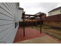 Back patio with a wooden pergola, offering an inviting outdoor space for relaxation and entertainment at 312 Villa Place Ct, Tucker, GA 30084